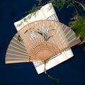 Traditional Chinese Su embroidery folding fan with bamboo frame and silk surface showing detailed embroidered patterns