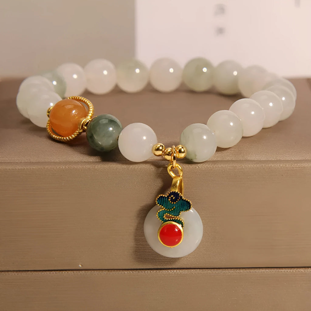 Women's ice jade crystal bracelet with pearl accents and a Xiangyun peace jade buckle.