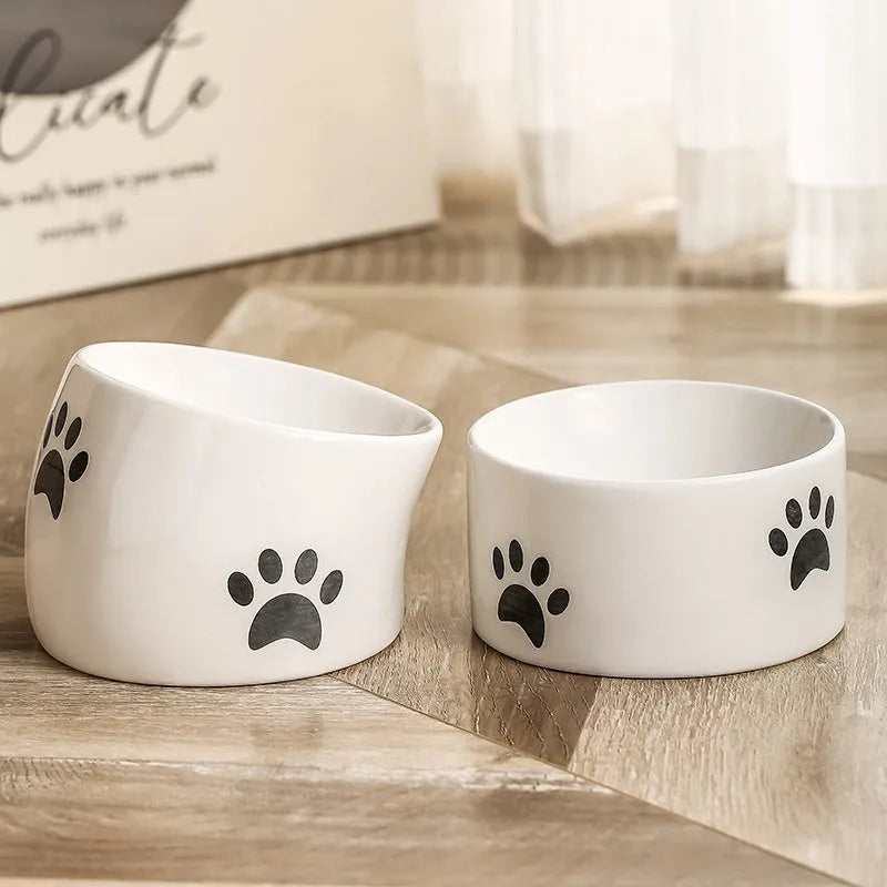 Ceramic cat bowl with high foot design and oblique mouth in cat's paw pattern