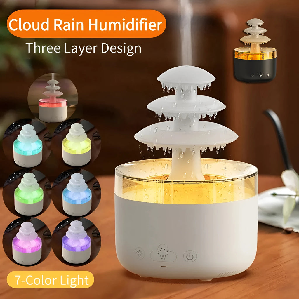 White cloud-shaped USB humidifier and essential oil diffuser with colourful mood lights on a wooden table.