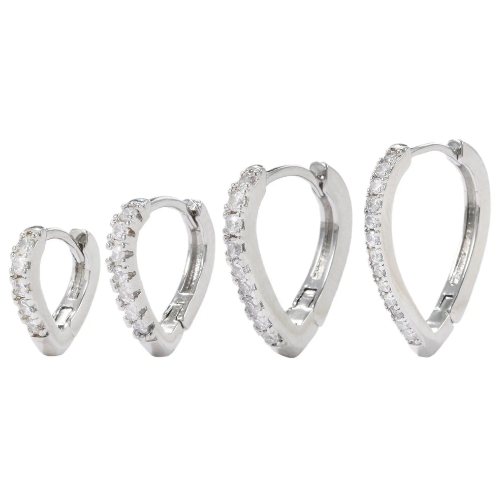 Geometric gold-coloured heart-shaped ear clip on a white background.