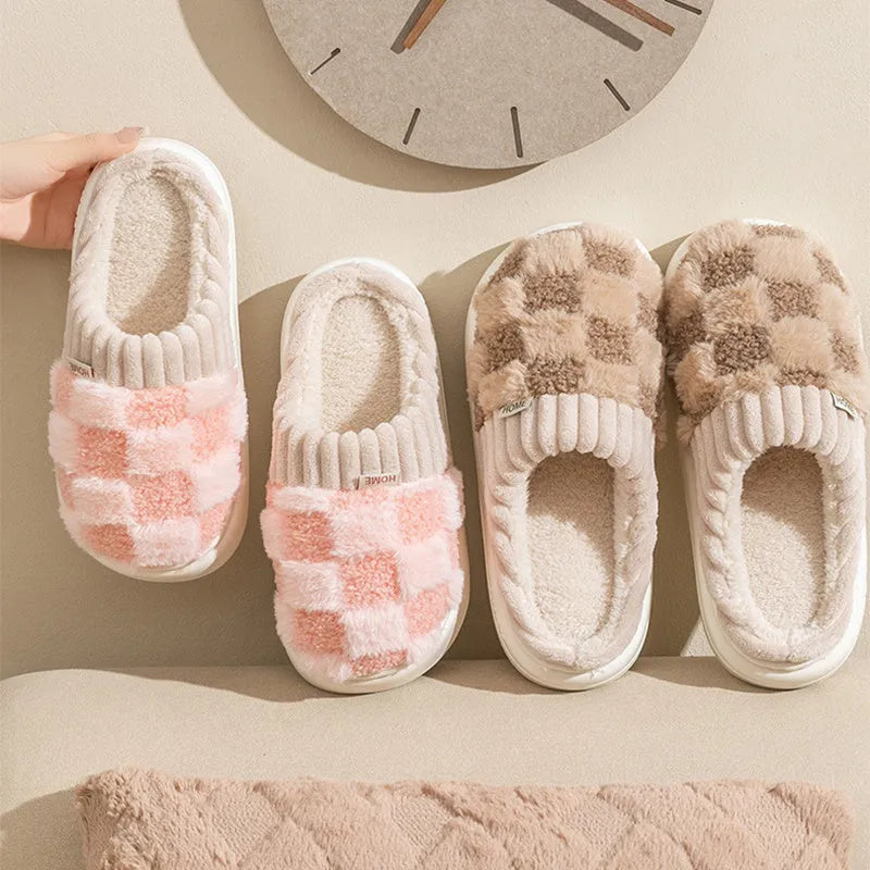 Plaid pattern women's plush slippers with round toe and flat heel on a coloured background.