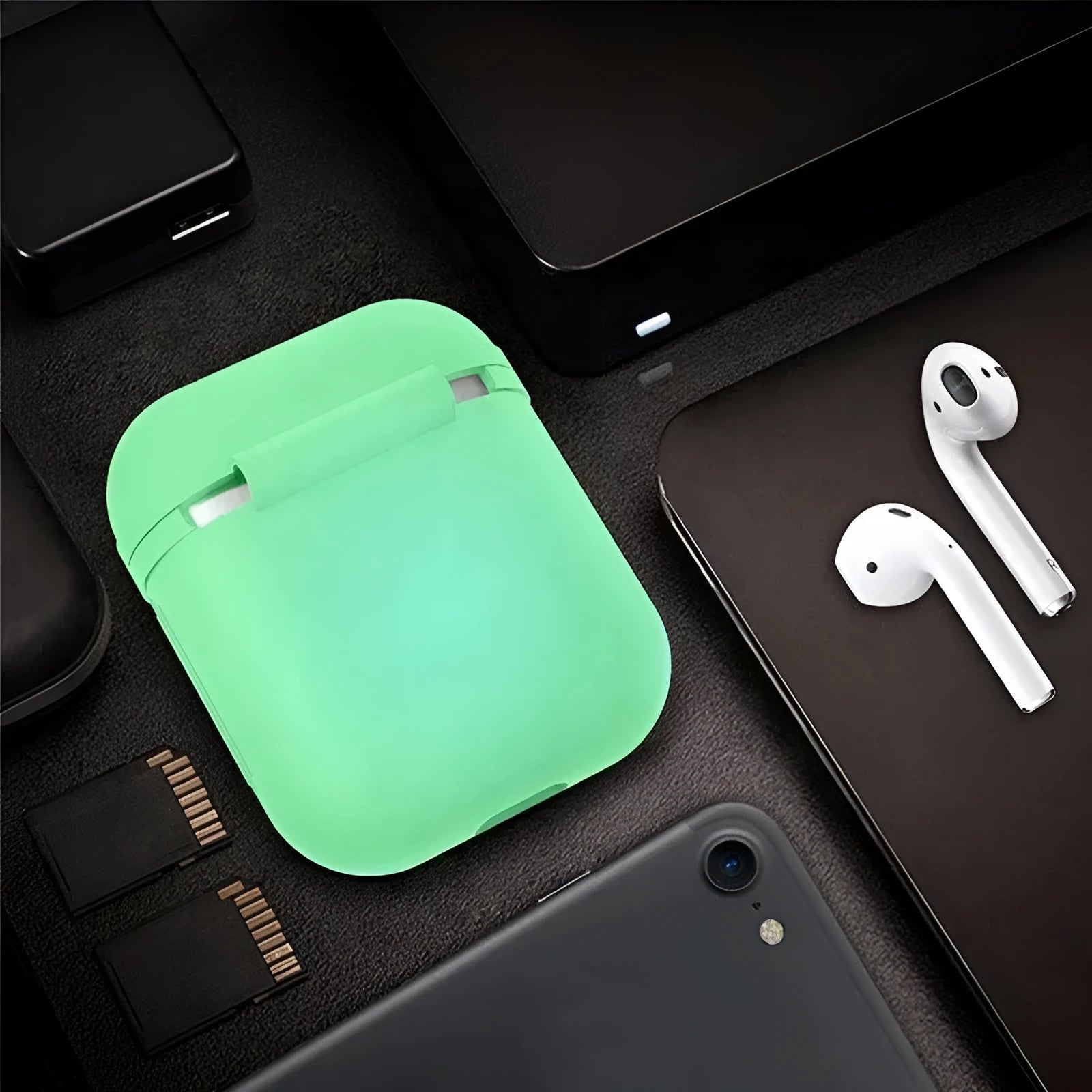 Luminous solid colour silicone flip-top protective case for AirPods on a white background.