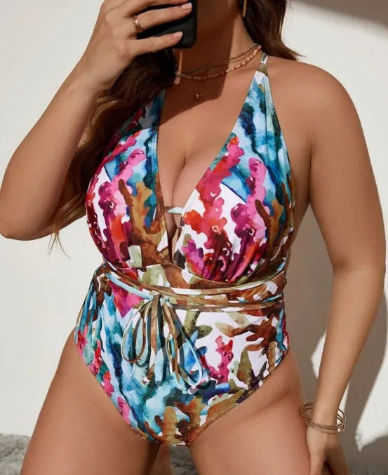 Purple or blue women's one-piece halter swimsuit on a hanger