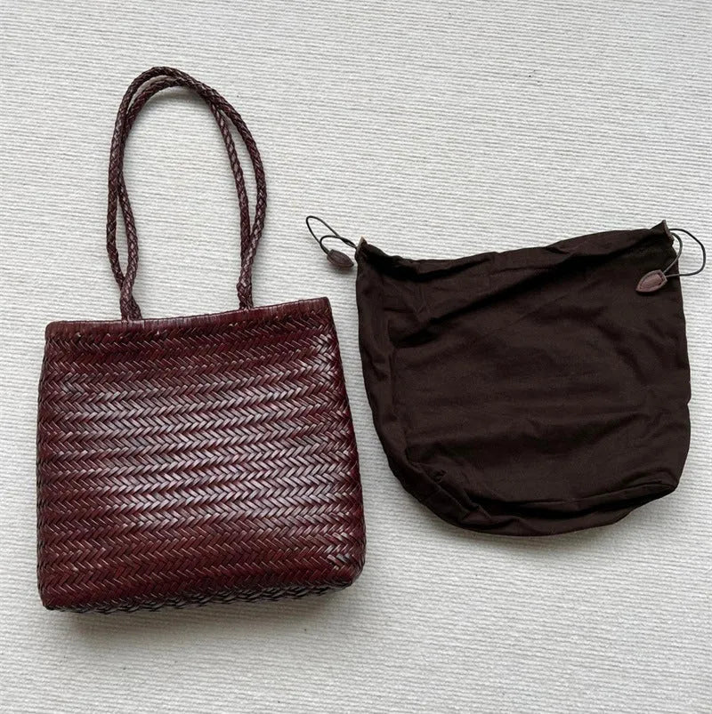 Brown handmade woven cowhide leather tote bag with a three-dimensional front pocket.