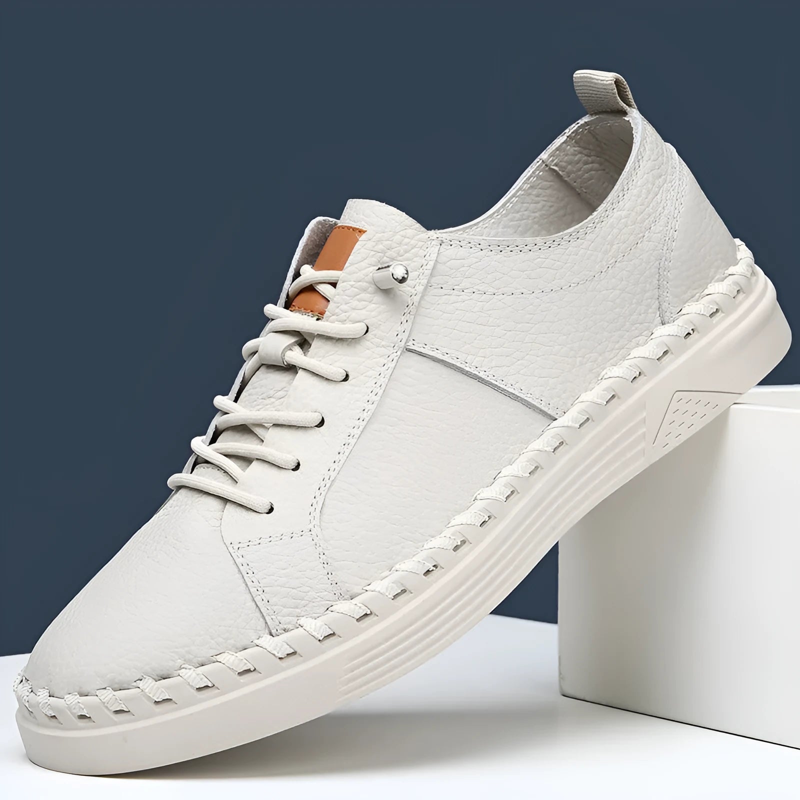 Men's beige and black cowhide leather sneakers with mesh lining and round toe.