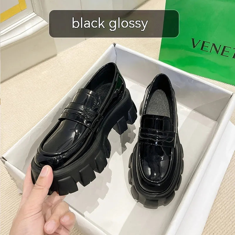 British style wide-fit loafers in patent leather with a muffin base heel and rubber sole.