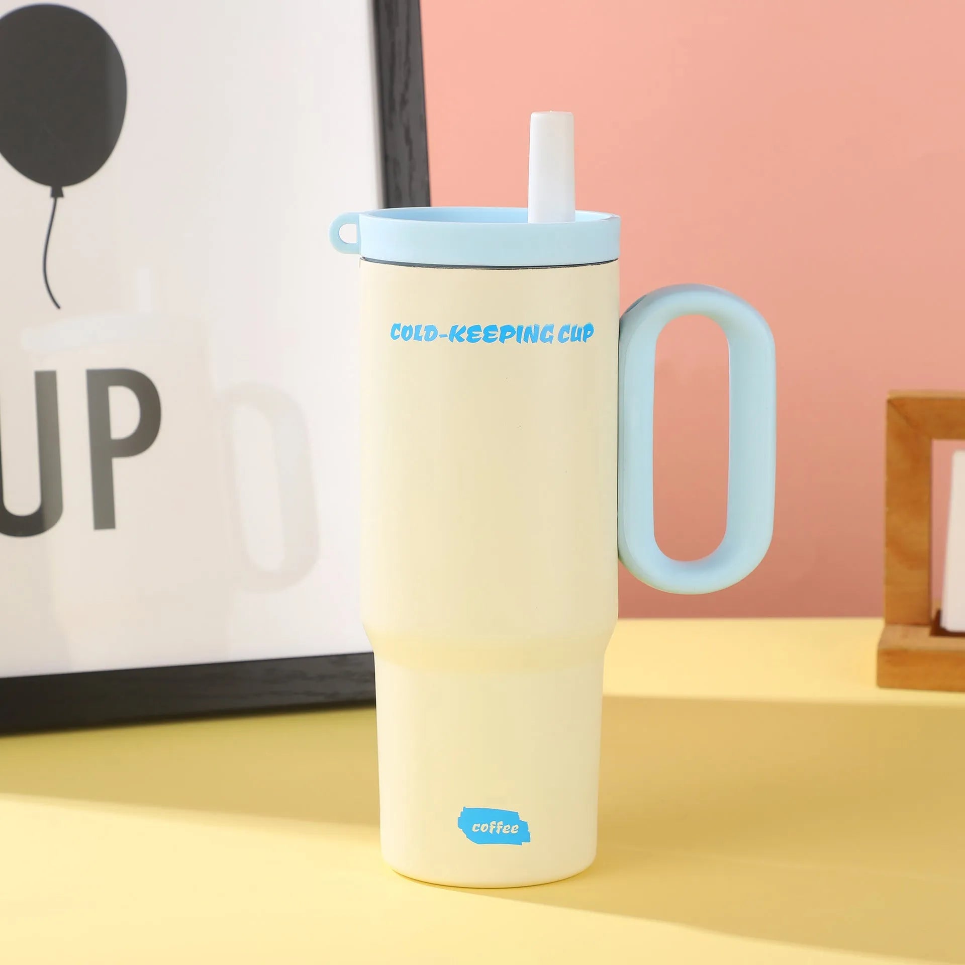 Insulated plastic straw cup with carry handle in five colour options showing 700ml capacity