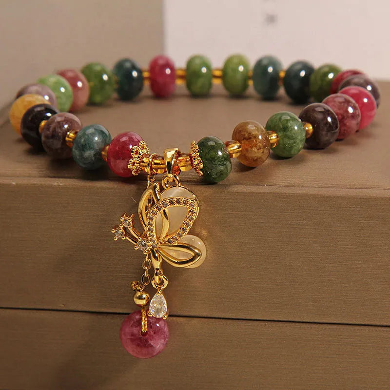 Colourful butterfly bracelet with alloy base and glass beads in tourmaline shades.
