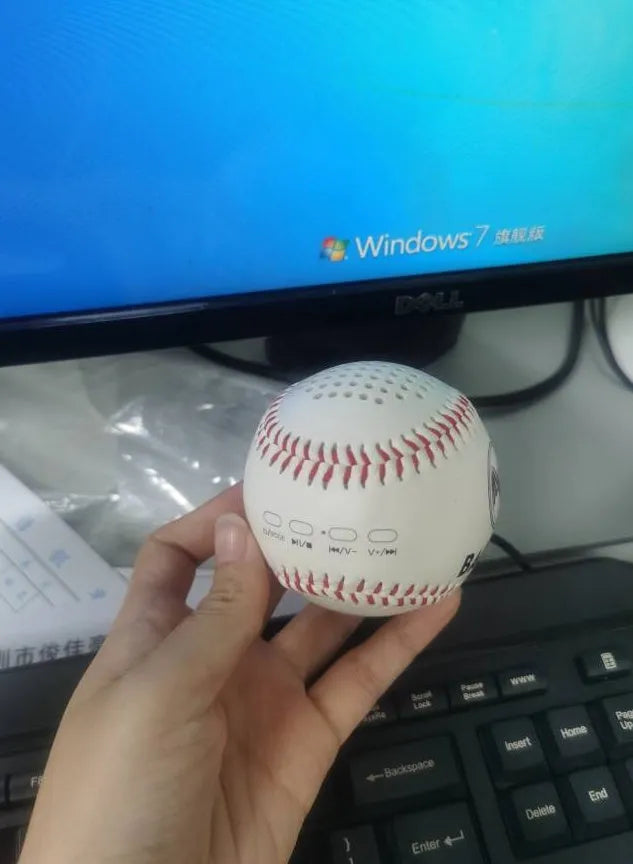 Baseball-style Bluetooth speaker in green colour showing compact design with likely control buttons.
