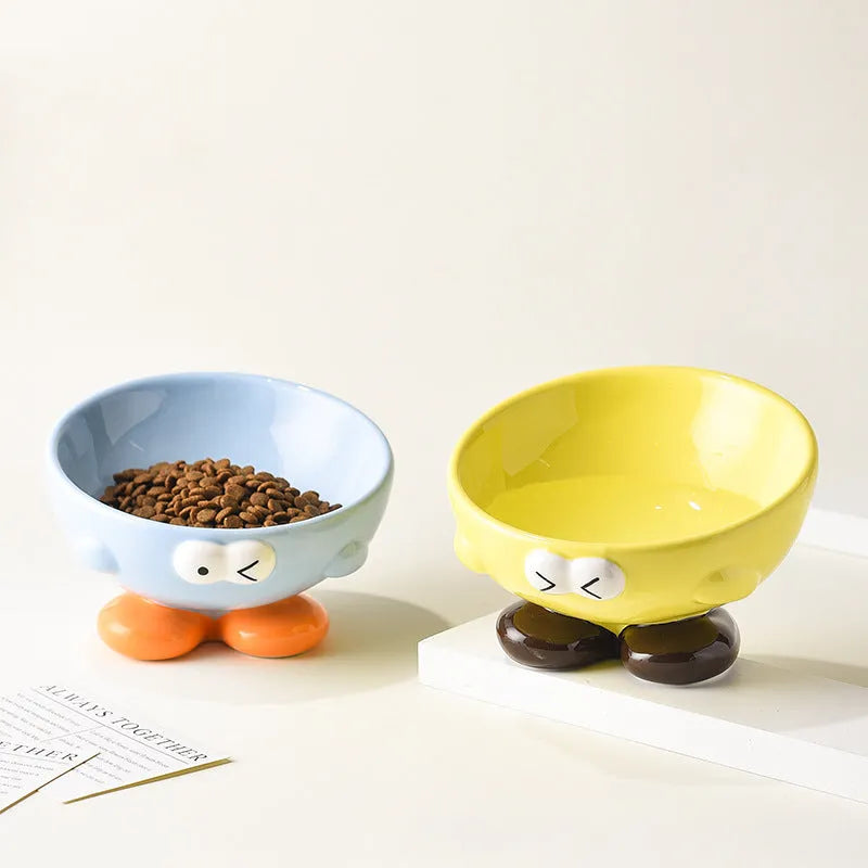 Blue ceramic oblique pet bowl with tall sides and a cute expression print for cervical spine support.
