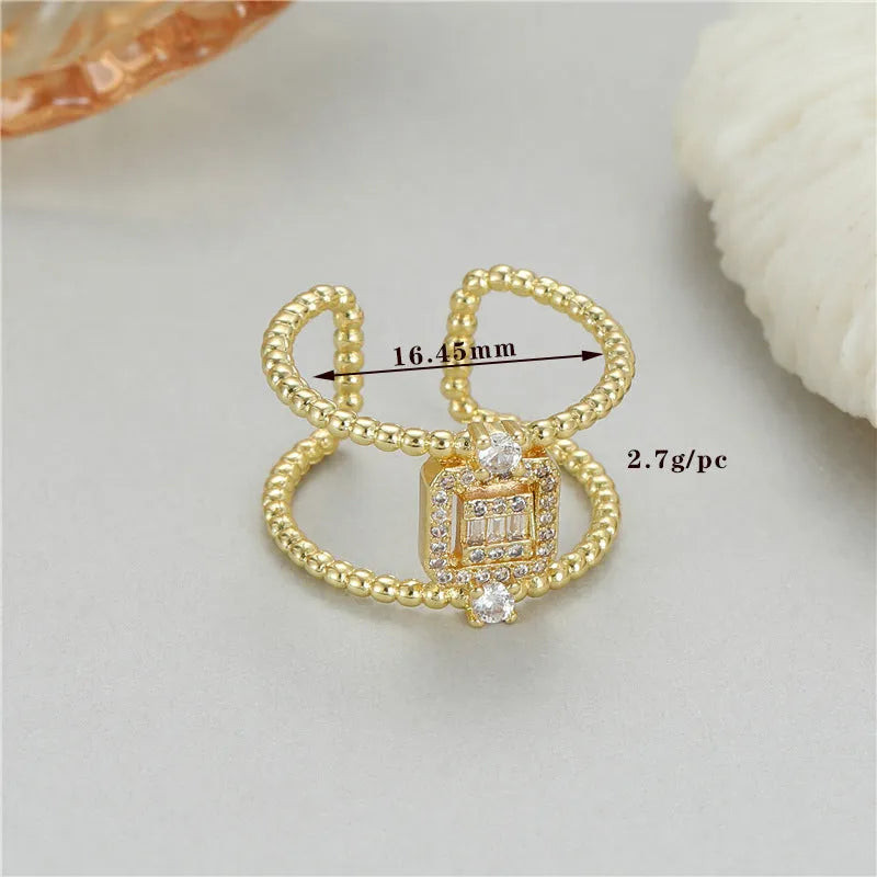 Copper open ring with gold plating and adjustable U-shaped design on a finger.