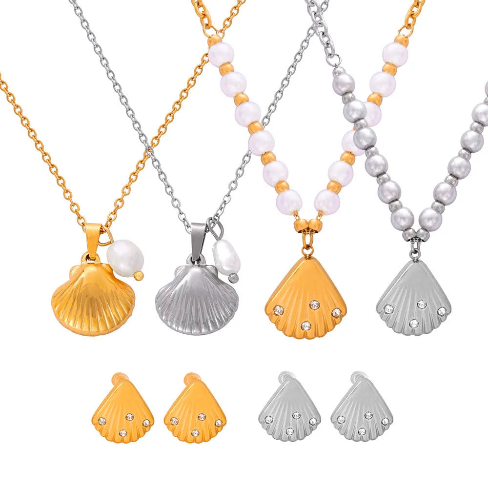 Gold tone vintage shell pendant necklace with a freshwater pearl bead on an O-shaped titanium steel chain.