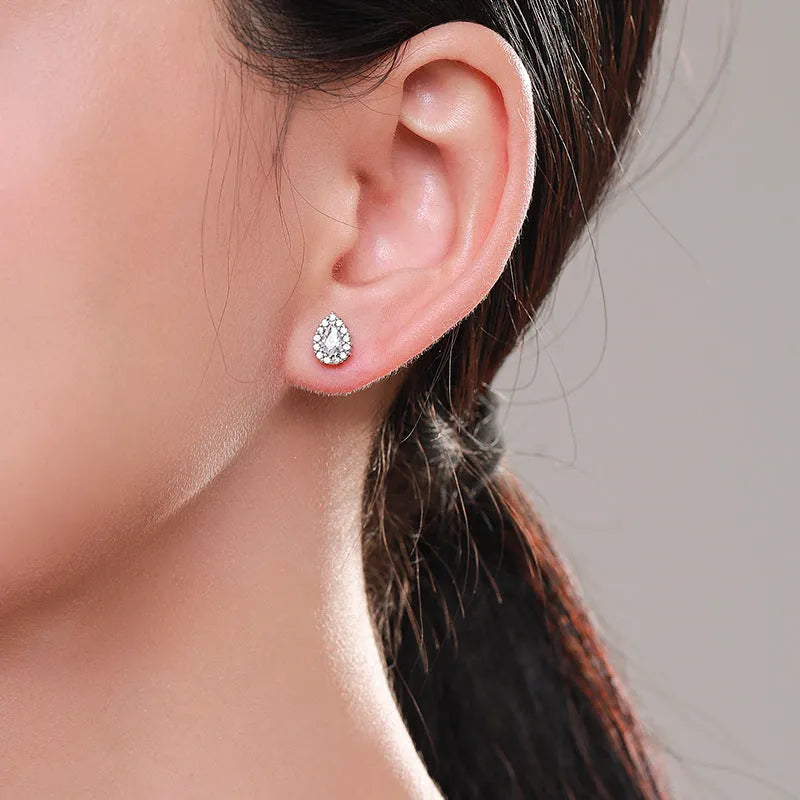 Close-up of women's silver water drop shaped ear studs made from 925 sterling silver.