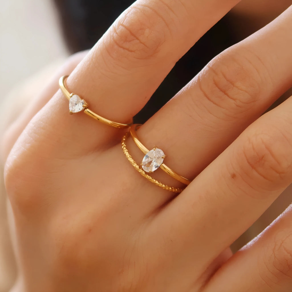 Golden stainless steel love heart or oval shaped simple bracelet ring for women in sizes 5 to 8