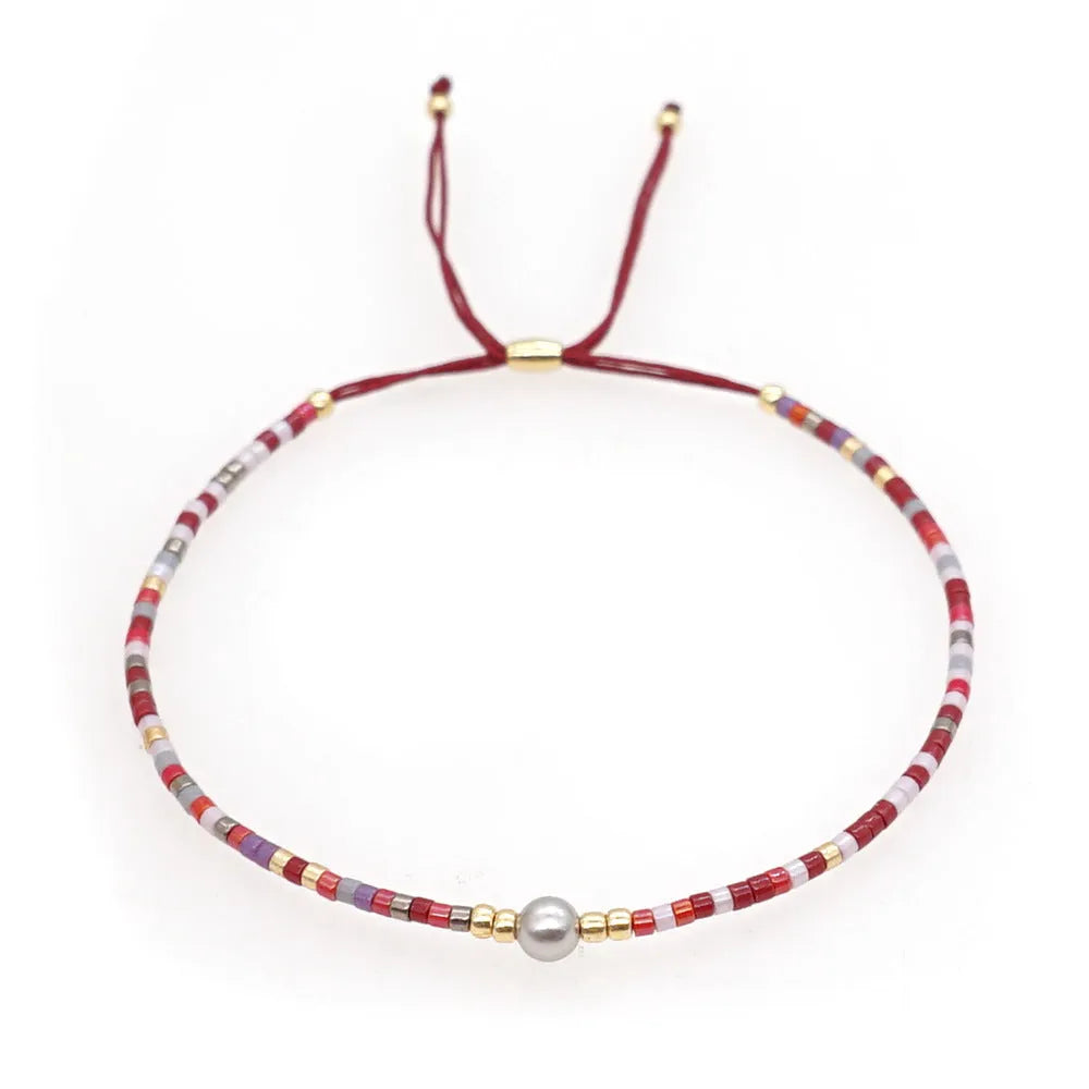 Women's handmade Bohemian bracelet with colourful geometric glass beads.