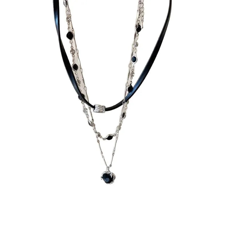 Women's creative double-layer necklace with heart-shaped crystal pendant and leather accents on an adjustable chain.