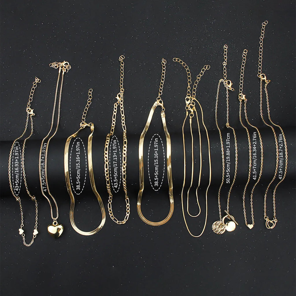 Set of ten gold electroplated women's necklaces with snake bone chains and alloy pendants.