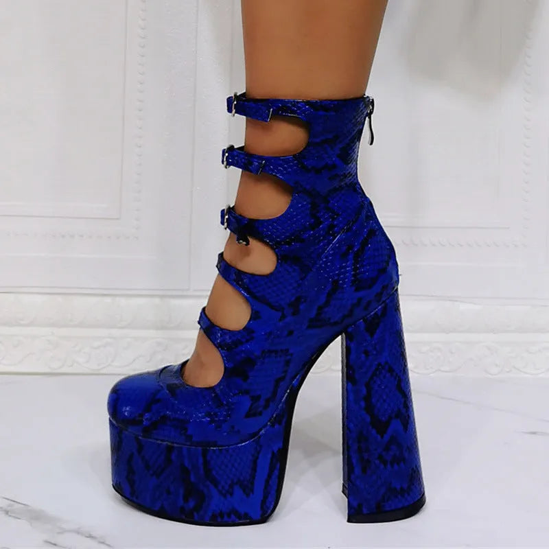 Women's black patent leather platform ankle boots with a serpentine buckle strap and thick heel.