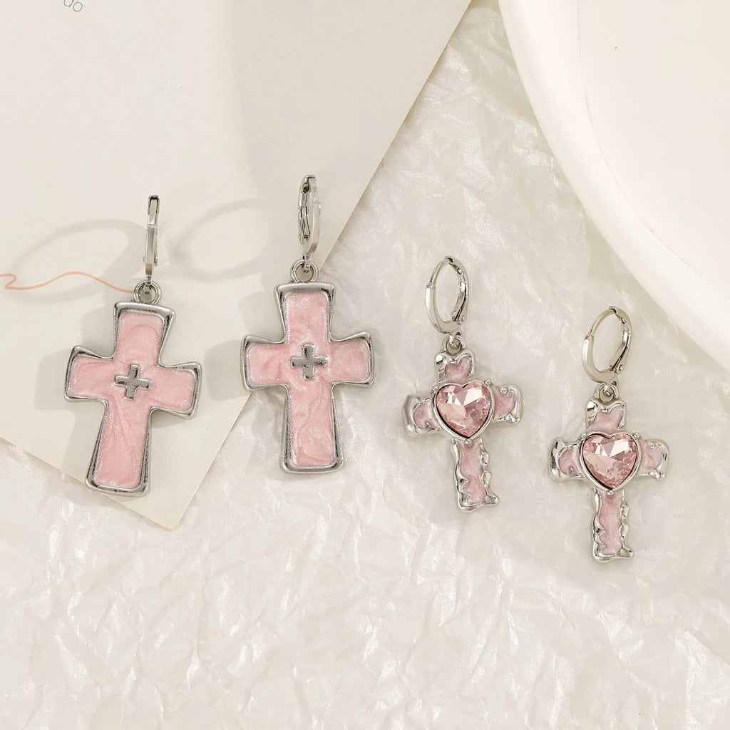 Women's classic alloy earrings with crystal detailing showing cross, heart, and cat designs in neutral white and silver colours