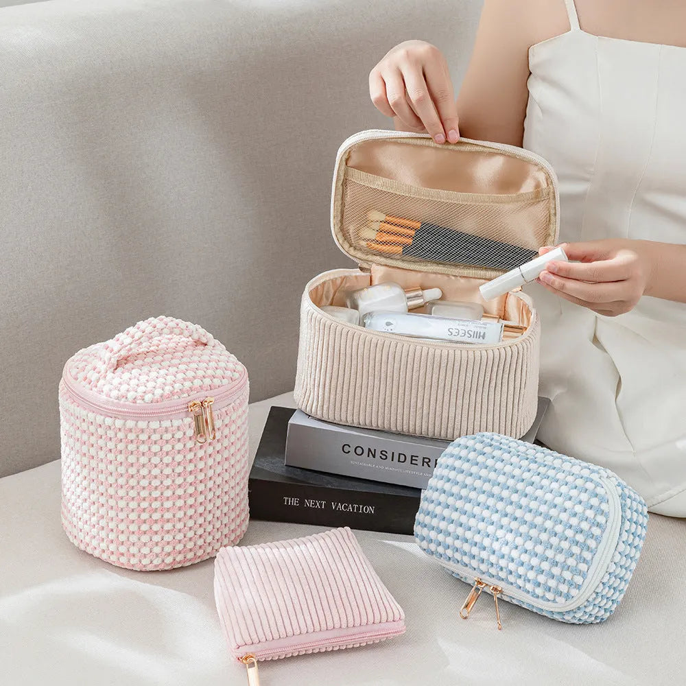 Four cube-shaped flannelette makeup bags in a set, shown in blue with dots colour