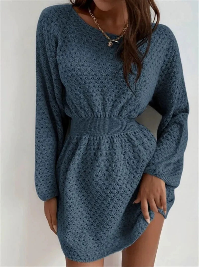 Blue women's knitted dress with hand-crocheted floral details, a round neck, and a fitted waist.