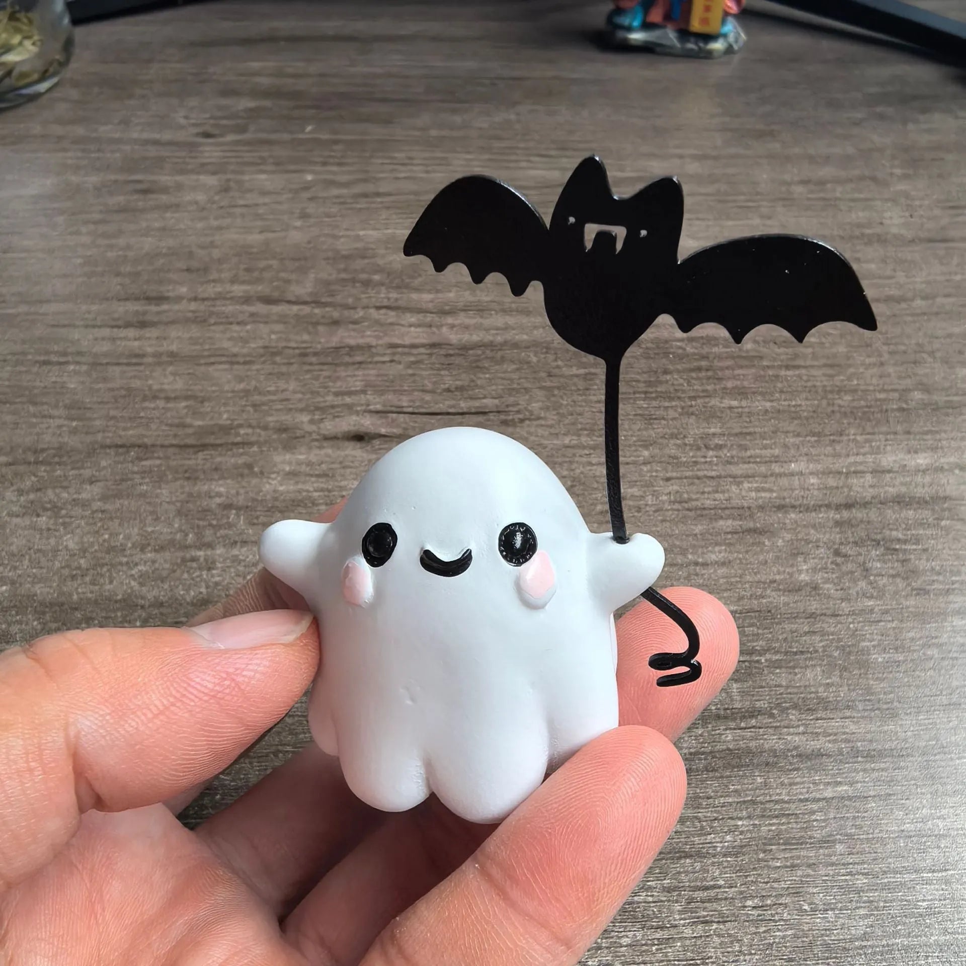 Small resin ghost walking dog statue with a bat, a Halloween decoration.