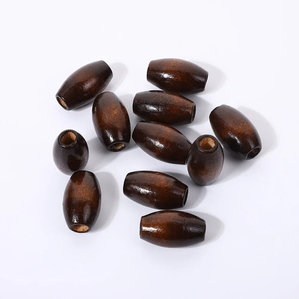 Dark coffee coloured oval wooden bead with M-shaped texture, shown next to a ruler showing 25mm size.