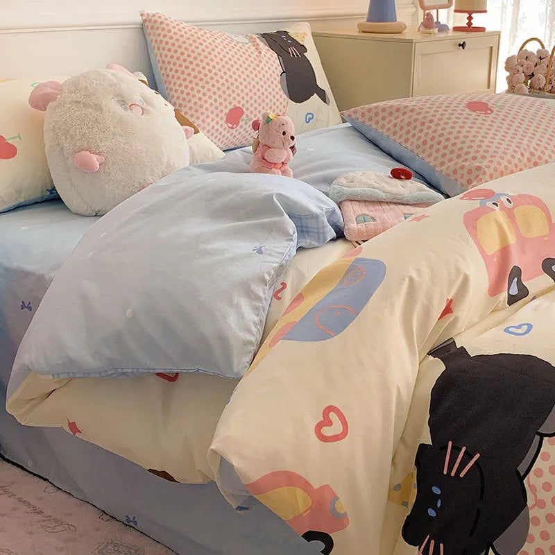 Cartoon dog pattern pure cotton duvet cover and pillowcases from a four-piece bedding set laid on a bed.