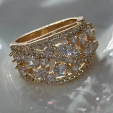 Women's round hollow fashion ring in gold or platinum with a diamond or blue sapphire stone.