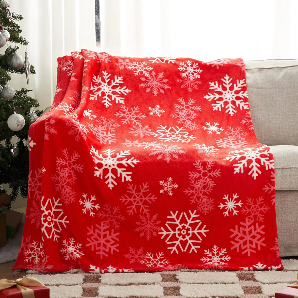 Soft red polyester flannel Christmas blanket draped over a sofa