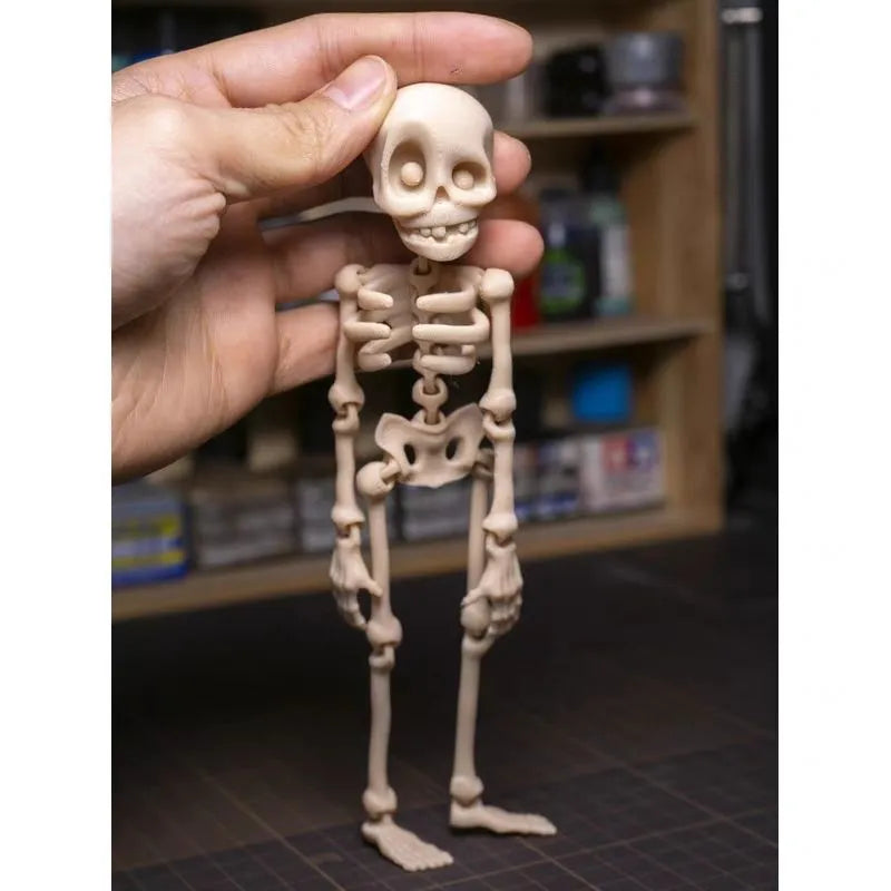 3D-printed white skull refrigerator magnet, 18cm tall, on a fridge door.