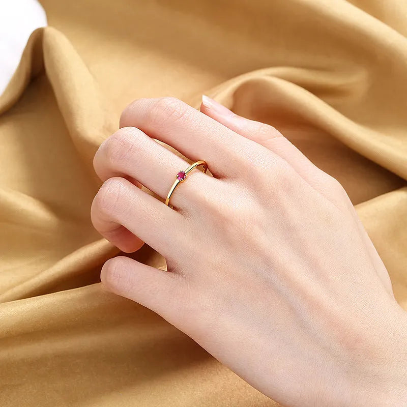 Copper women's ring with twin circle geometric design and a single central diamond, shown in blue.