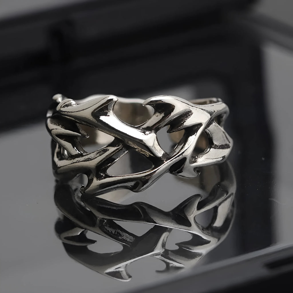 Copper adjustable ring with geometric thorn and flower design in J2150 colour on a hand.