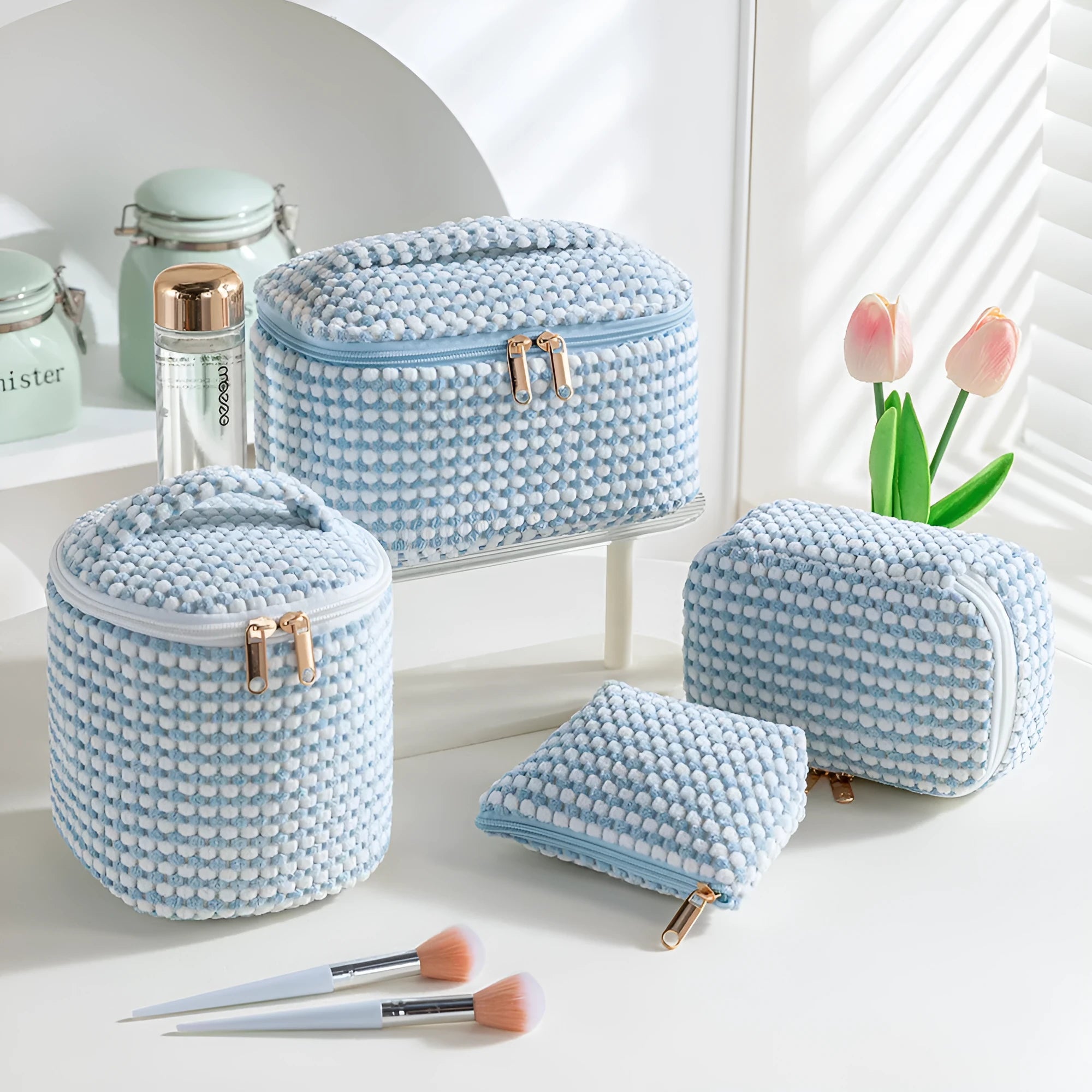Four cube-shaped flannelette makeup bags in a set, shown in blue with dots colour