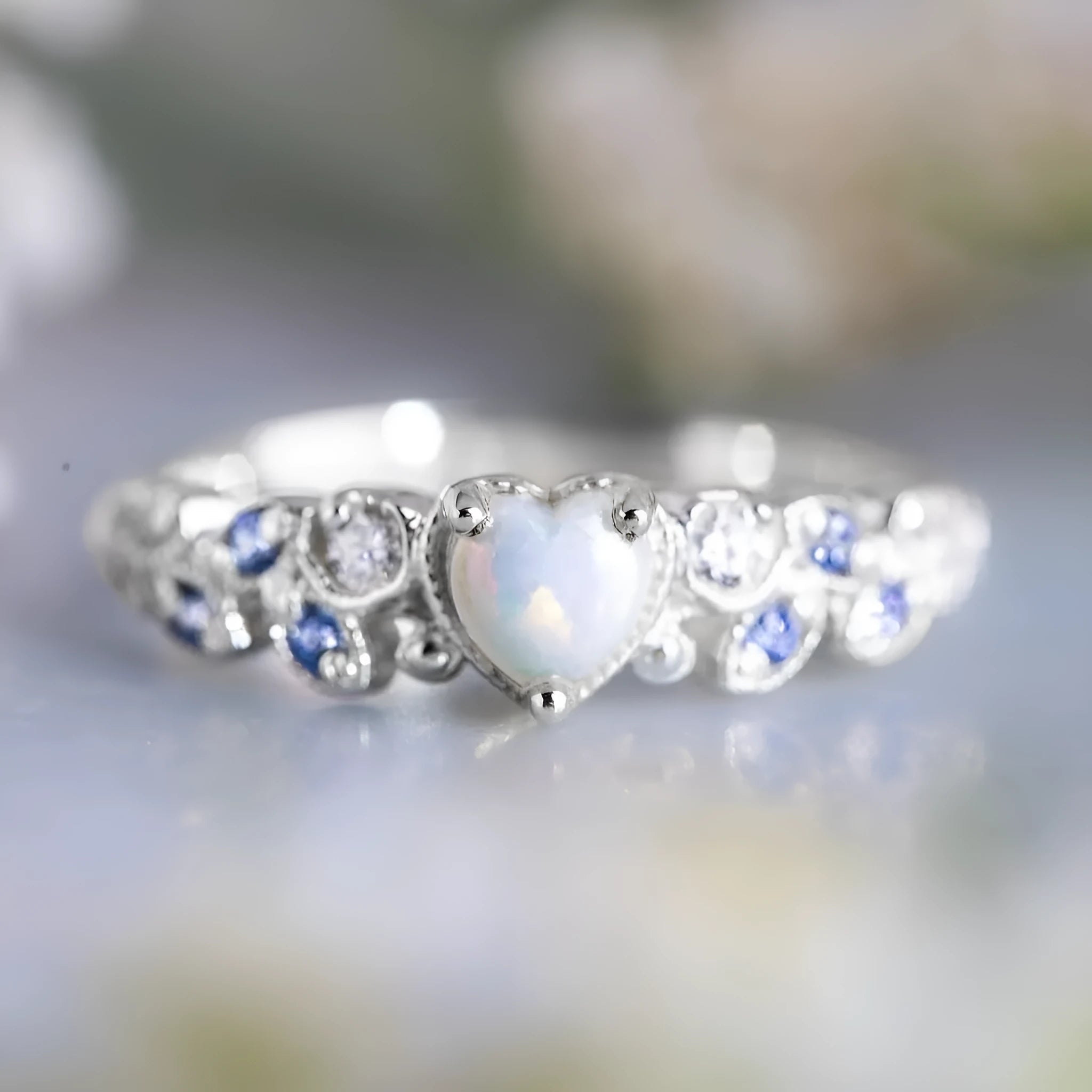 Women's peach-coloured heart-shaped alloy ring with floral and opal ocean detailing.