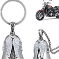 Vintage white angel feather alloy keychain and necklace on a dark background.