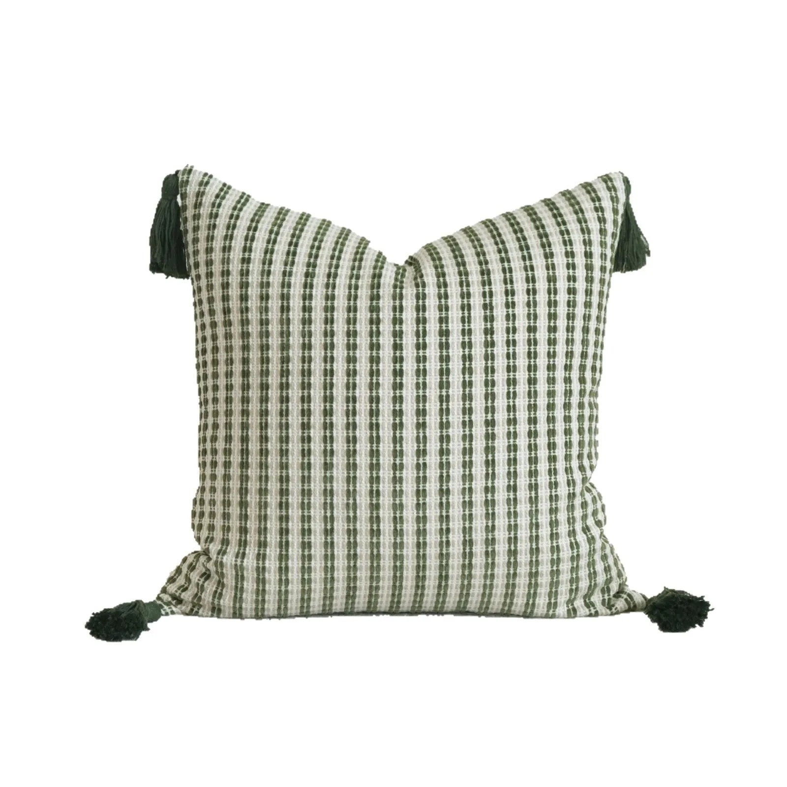 Green striped and leaf patterned hotel pillow with tassel trim on a bed.