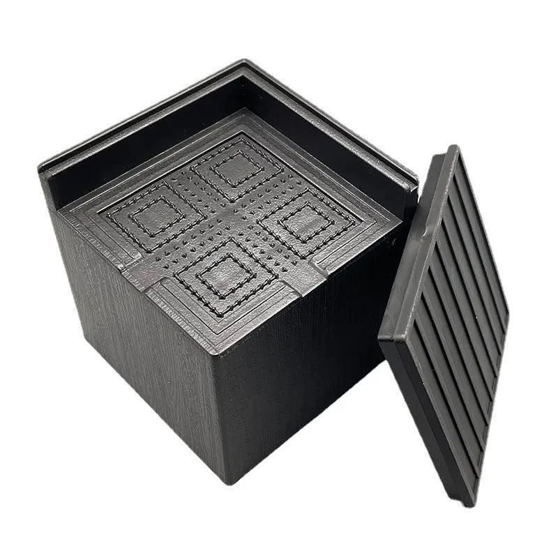 Four black plastic bed risers for increasing furniture height