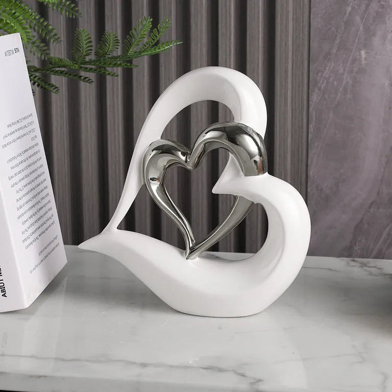 Modern white porcelain heart ornament with a geometric shape on a wooden surface.