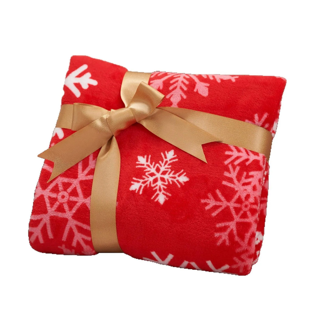 Soft red polyester flannel Christmas blanket draped over a sofa