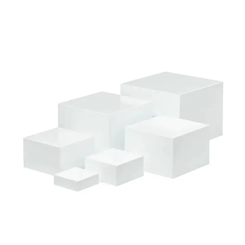 White plastic modular dessert display stand with six stackable suit cube racks on a table.