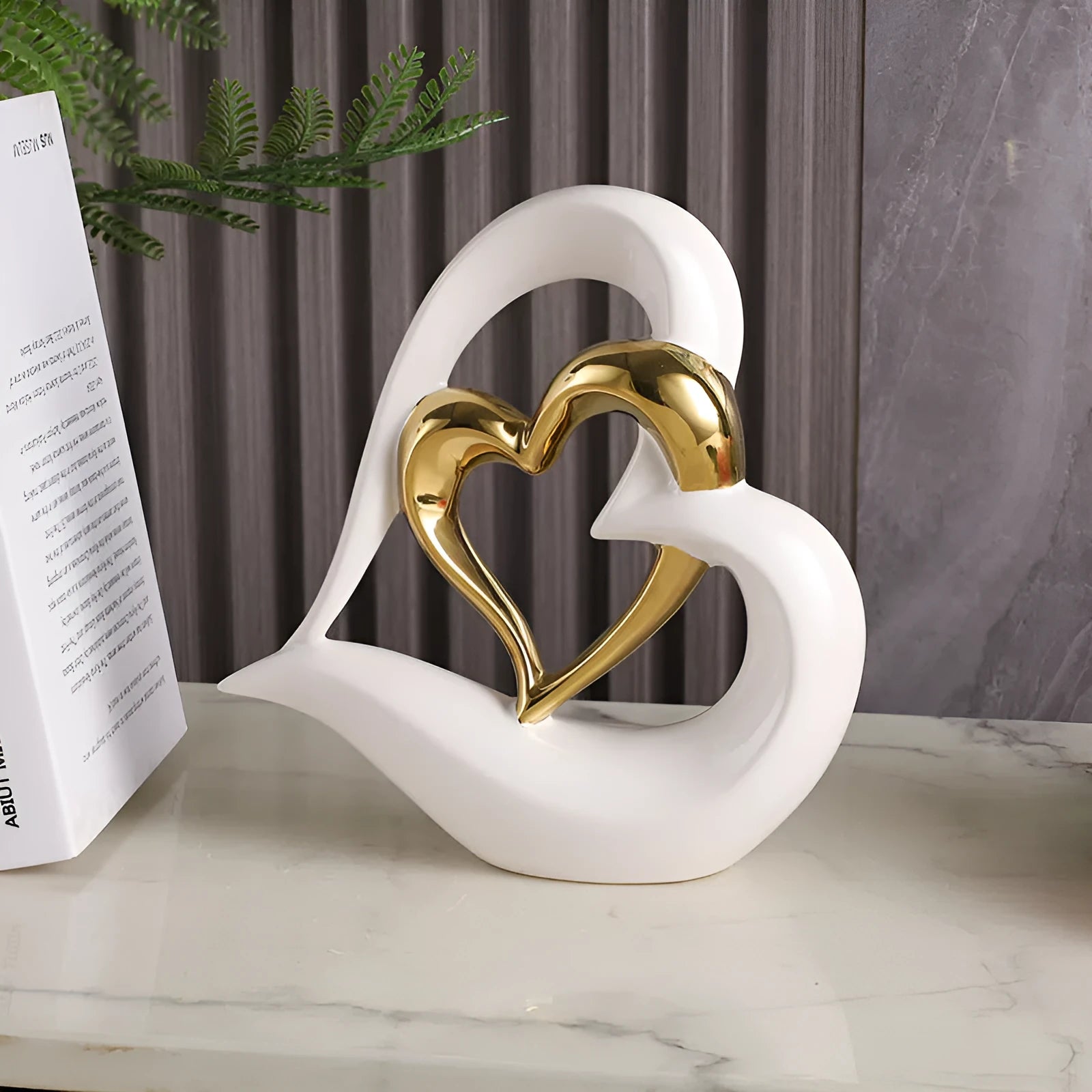 Modern white porcelain heart ornament with a geometric shape on a wooden surface.