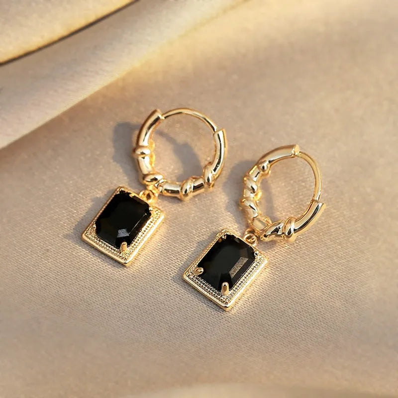 A pair of geometric quadrilateral copper earrings with black zircon stones in a French court retro style, colour E2506 Black.