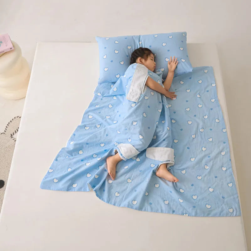 Anti-kick sleeping bag style blanket in a colourful pattern on a bed.