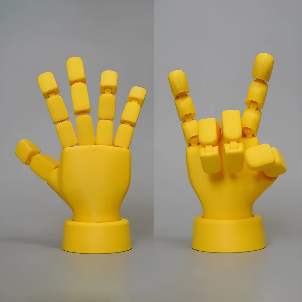 Yellow articulated PLA hand prop with movable fingers on a neutral background.