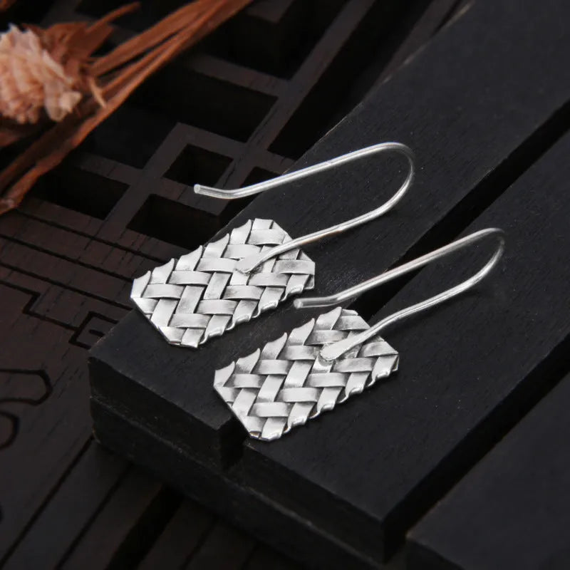 Silver geometric plaid pattern drop earrings with woven diamond design