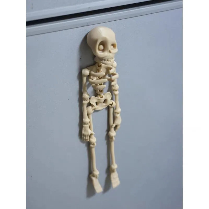 3D-printed white skull refrigerator magnet, 18cm tall, on a fridge door.