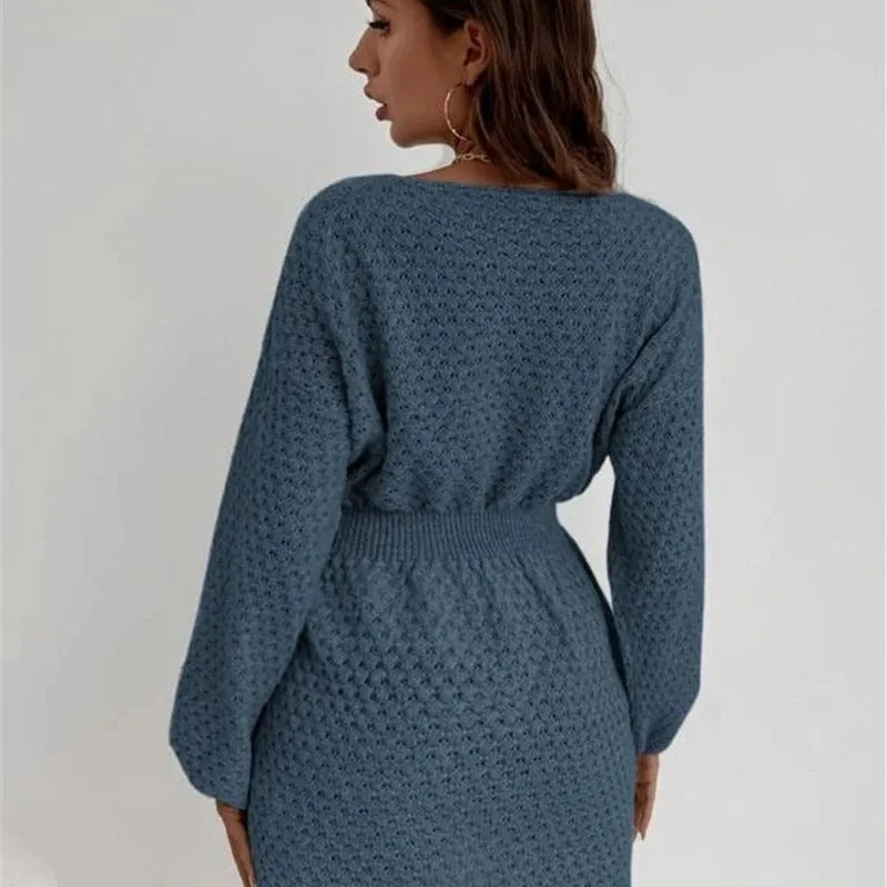 Blue women's knitted dress with hand-crocheted floral details, a round neck, and a fitted waist.