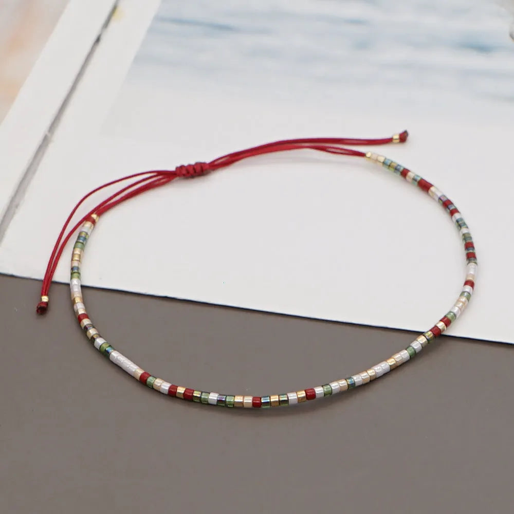 Women's handmade Bohemian bracelet with colourful geometric glass beads.